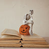 Resin Skeleton Sitting on Flocked Jack-O-Lantern